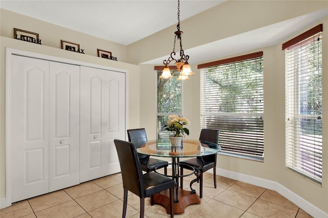 tiled dining space with a chandelier