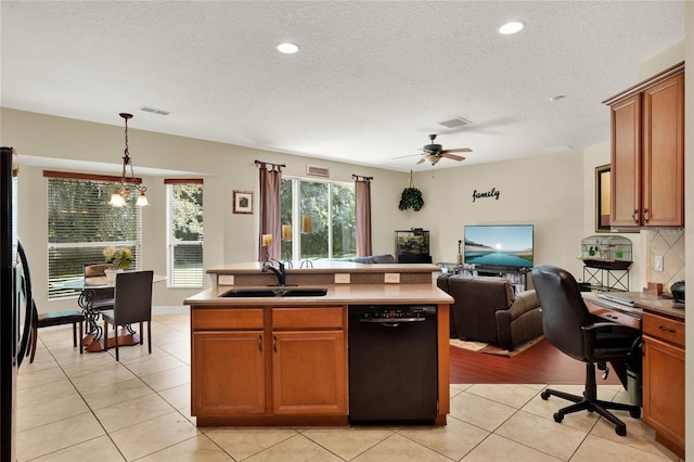 kitchen with sink, decorative light fixtures, a kitchen island with sink, black dishwasher, and ceiling fan with notable chandelier