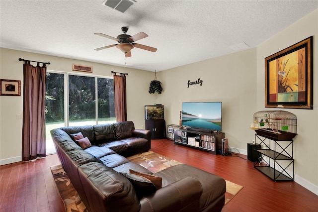 living room with ceiling fan, a textured ceiling, and hardwood / wood-style floors