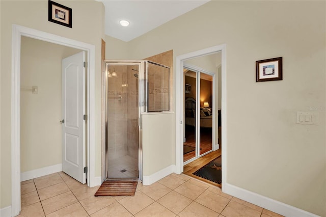 bathroom with tile patterned flooring and walk in shower