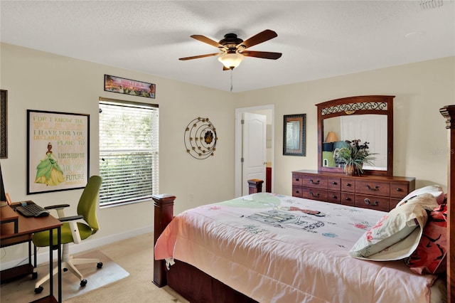 bedroom with a textured ceiling, ceiling fan, and light colored carpet