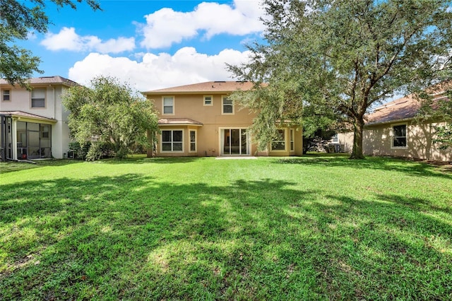 rear view of house with a lawn