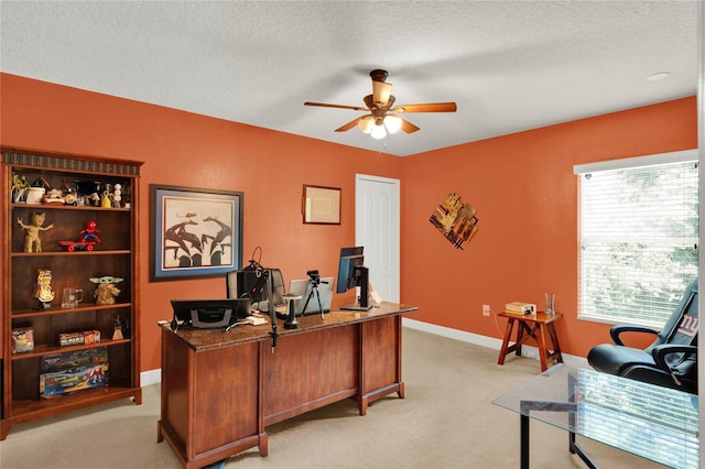 office area with a textured ceiling, ceiling fan, light carpet, and a wealth of natural light