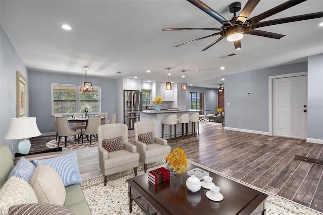 living room featuring light wood-type flooring and ceiling fan