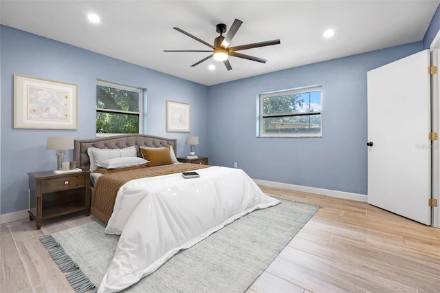 bedroom with ceiling fan and light hardwood / wood-style floors