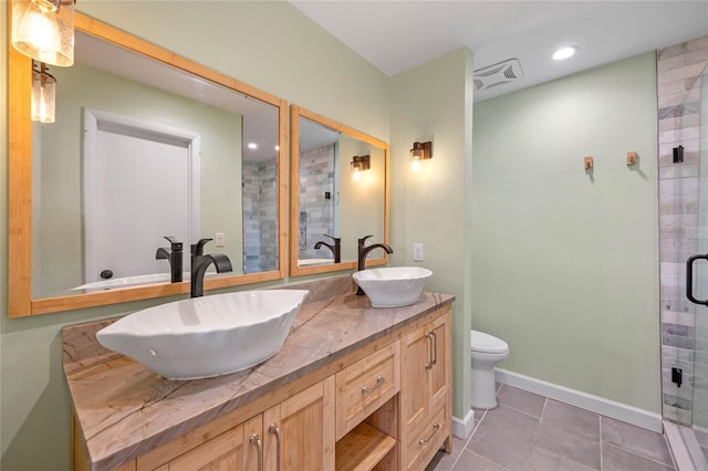 bathroom with toilet, vanity, tile patterned floors, and an enclosed shower