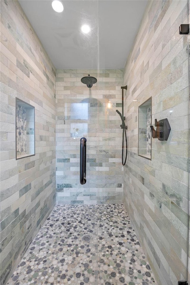 bathroom with a shower with door