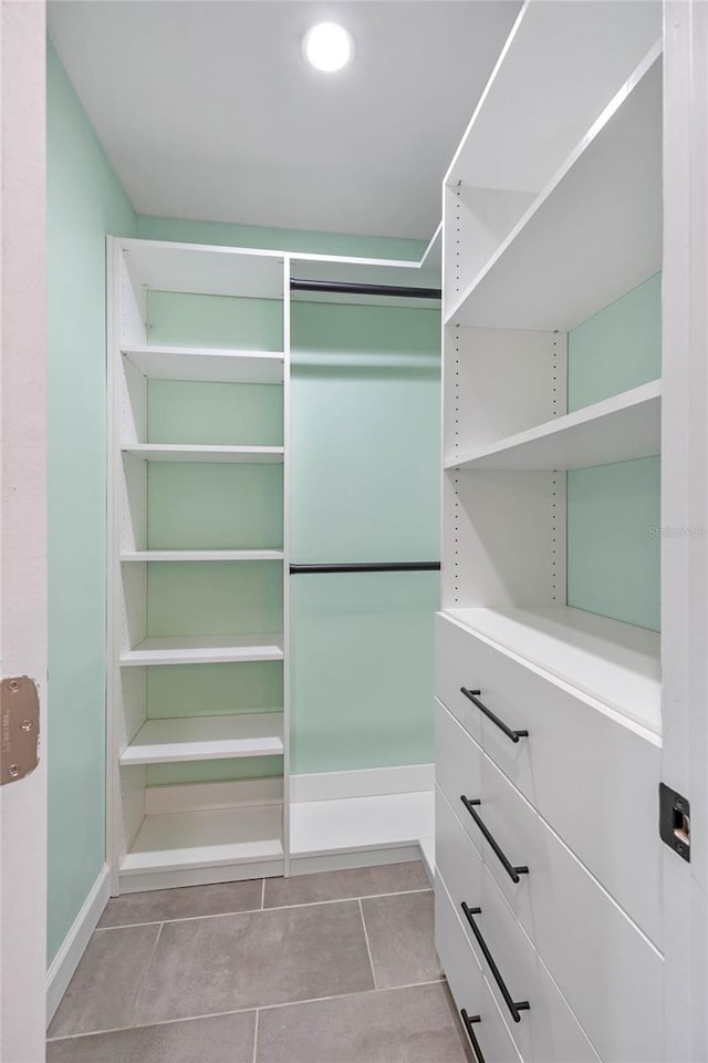 spacious closet featuring light tile patterned floors