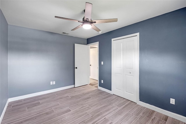 unfurnished bedroom with ceiling fan, light hardwood / wood-style floors, and a closet