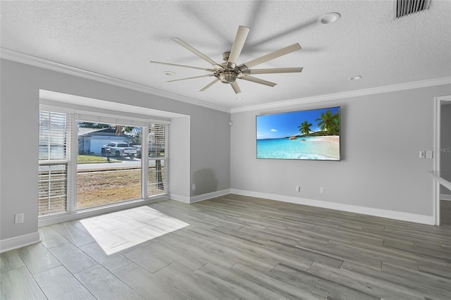 unfurnished living room featuring ceiling fan, a textured ceiling, and ornamental molding