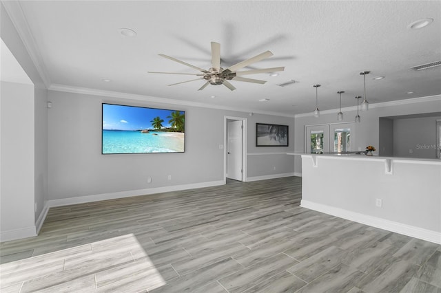 unfurnished living room featuring crown molding, french doors, ceiling fan, and light hardwood / wood-style flooring