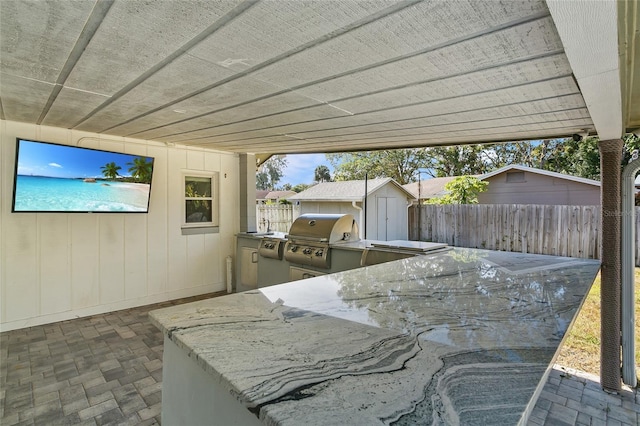 view of patio with area for grilling and a grill