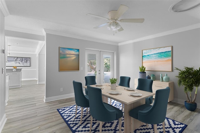 dining room featuring french doors, light wood-type flooring, ceiling fan, and ornamental molding