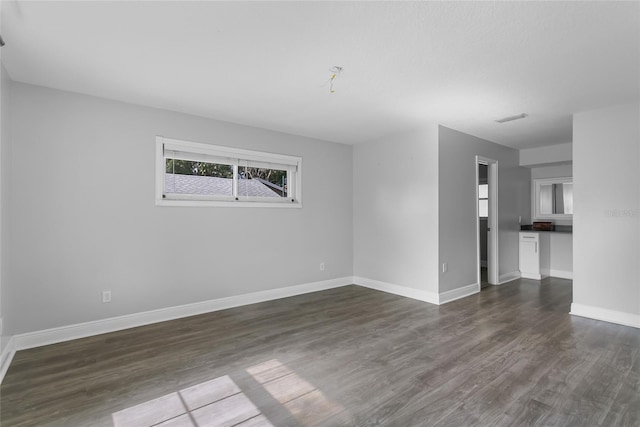 empty room featuring dark hardwood / wood-style flooring