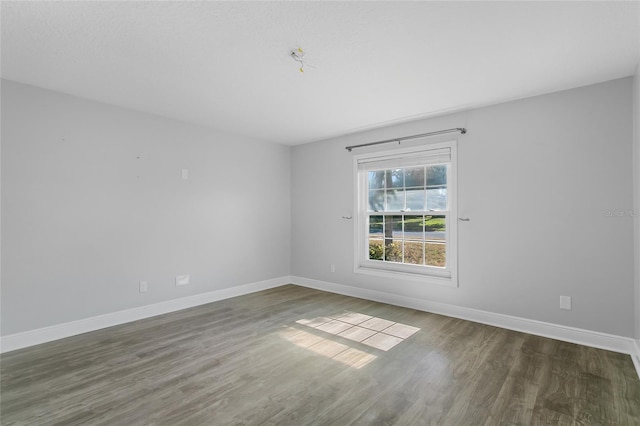 spare room with dark hardwood / wood-style floors