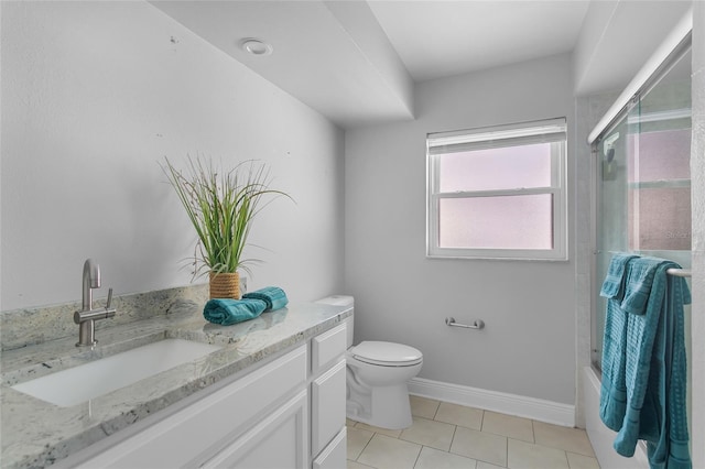 full bathroom featuring tile patterned flooring, vanity, toilet, and bath / shower combo with glass door