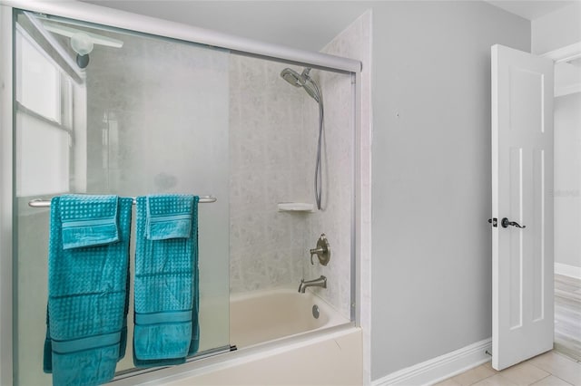 bathroom with tile patterned floors and combined bath / shower with glass door