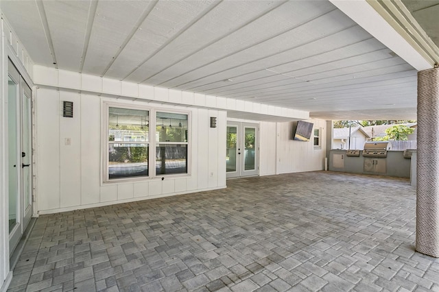 view of patio with french doors, an outdoor kitchen, and grilling area