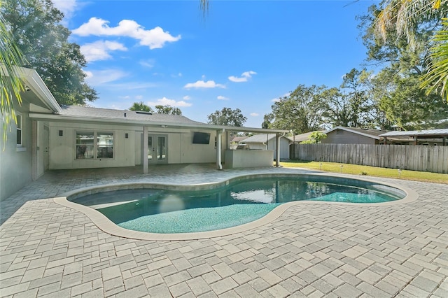 view of swimming pool with a patio area and french doors