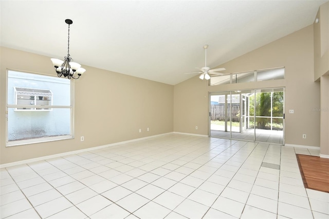 empty room featuring light tile patterned floors, ceiling fan with notable chandelier, and high vaulted ceiling