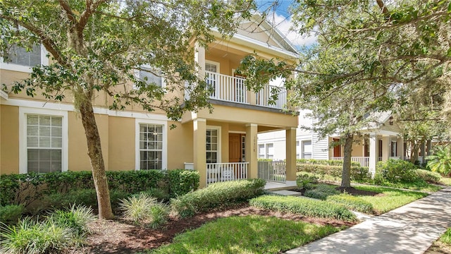 view of front of home featuring covered porch and a balcony