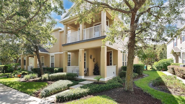 view of front of property with a porch and a balcony