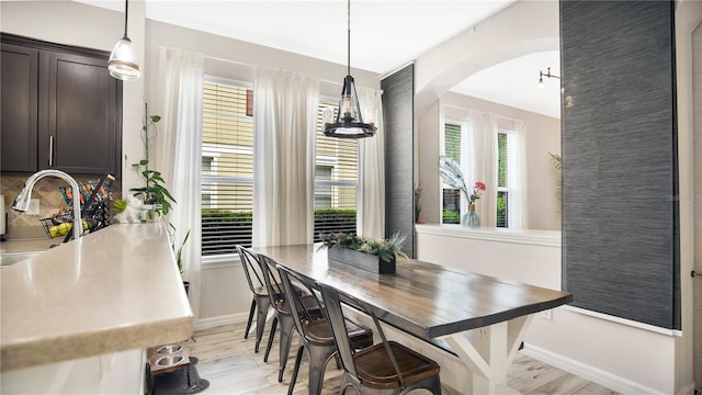 dining space with sink and light hardwood / wood-style flooring