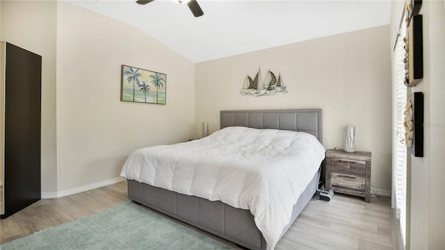 bedroom with vaulted ceiling, light wood-type flooring, and ceiling fan