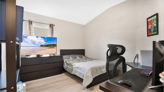 bedroom featuring light hardwood / wood-style flooring and lofted ceiling