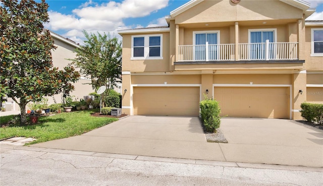 townhome / multi-family property featuring a garage and a balcony