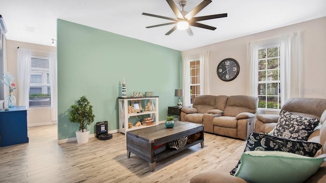 living room with light hardwood / wood-style floors and ceiling fan