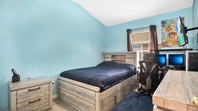 bedroom with lofted ceiling and carpet floors