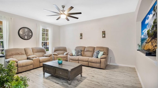 living room featuring light hardwood / wood-style flooring and ceiling fan