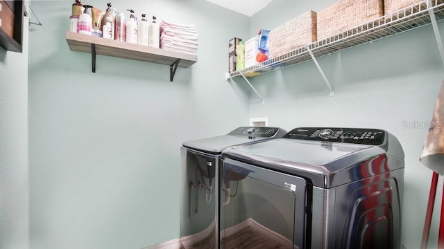 washroom with washing machine and clothes dryer