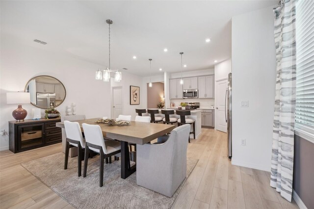 dining space with light hardwood / wood-style flooring and a wealth of natural light