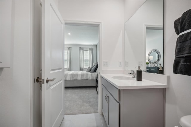 bathroom featuring tile patterned flooring, vanity, and toilet