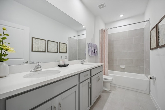 full bathroom with shower / tub combo with curtain, vanity, toilet, and tile patterned floors