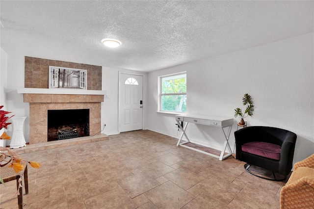 interior space with a fireplace and a textured ceiling