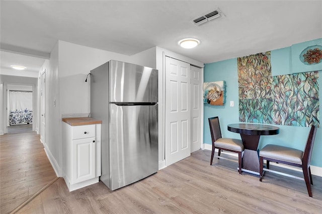 kitchen featuring light wood-type flooring and stainless steel refrigerator