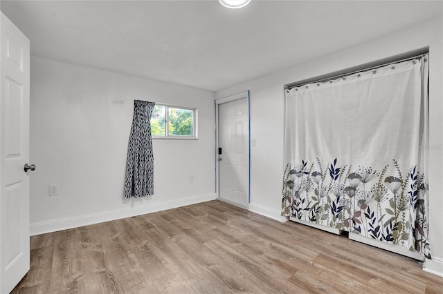 spare room featuring light wood-type flooring