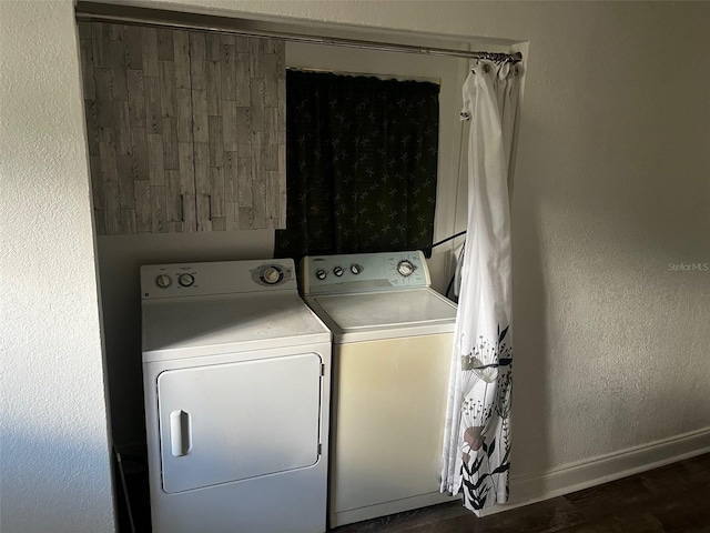 clothes washing area featuring dark hardwood / wood-style flooring and independent washer and dryer