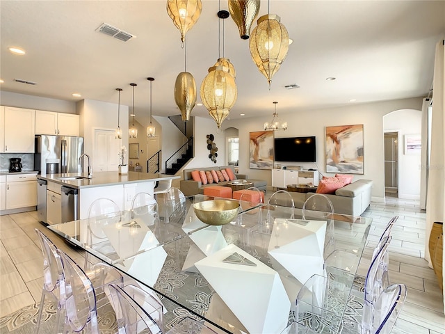 dining area with a chandelier and sink