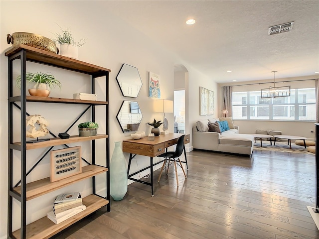 office featuring a textured ceiling, a chandelier, and hardwood / wood-style floors