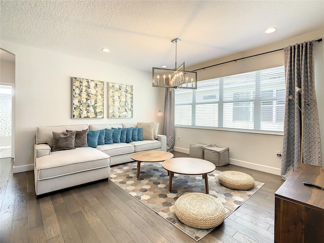 living room featuring plenty of natural light and dark hardwood / wood-style flooring