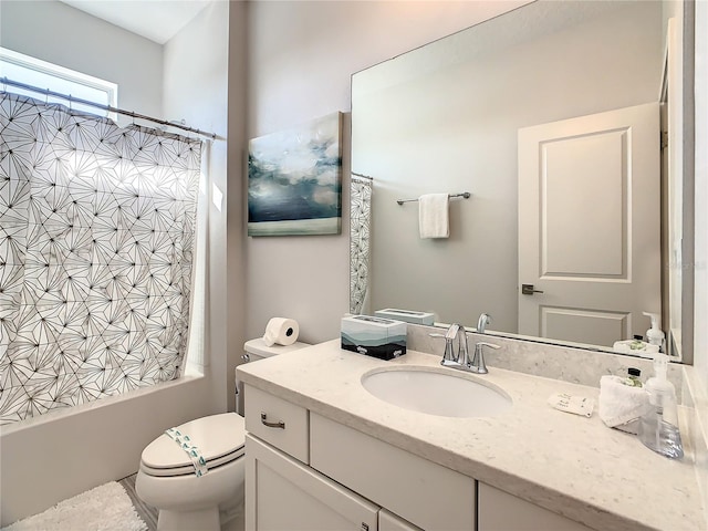 full bathroom featuring shower / bathtub combination with curtain, vanity, and toilet