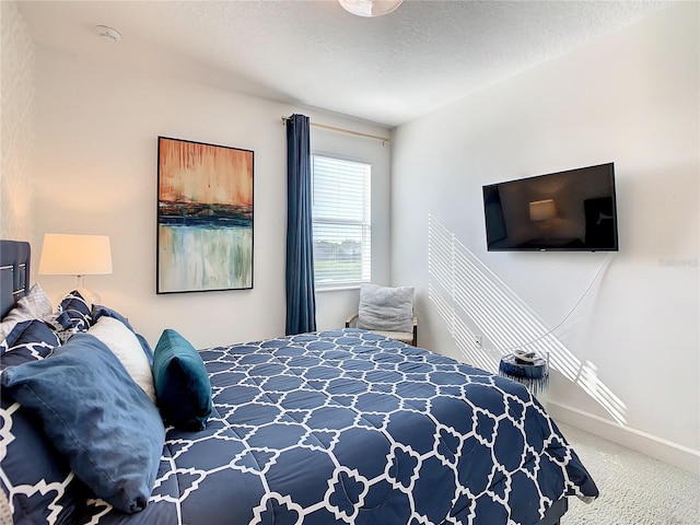 bedroom with a textured ceiling and carpet flooring