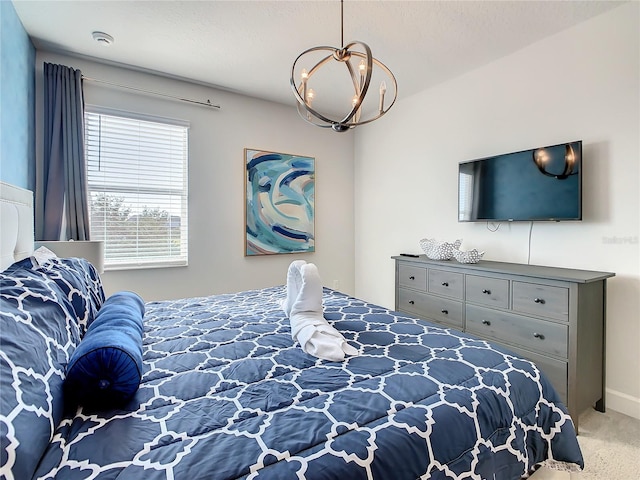 carpeted bedroom featuring a notable chandelier