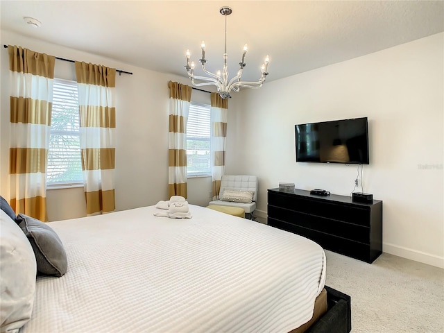 bedroom with an inviting chandelier, carpet flooring, and multiple windows