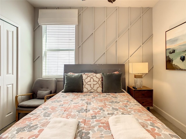 bedroom with carpet and a closet