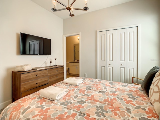 bedroom featuring an inviting chandelier, connected bathroom, and a closet